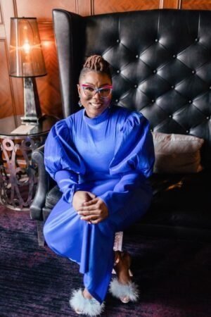 Dr. Foster seated in a blue outfit